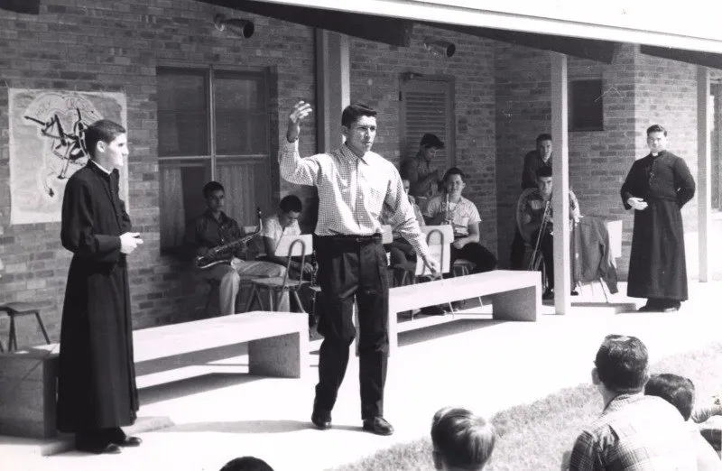 Brothers of Holy Cross with students in the campus courtyard in the 1960s