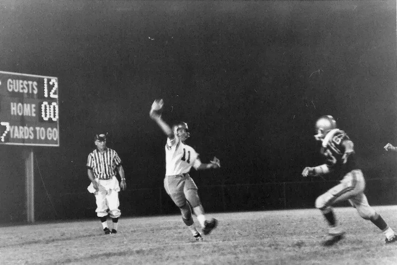 A night football game in the early years, with the scoreboard