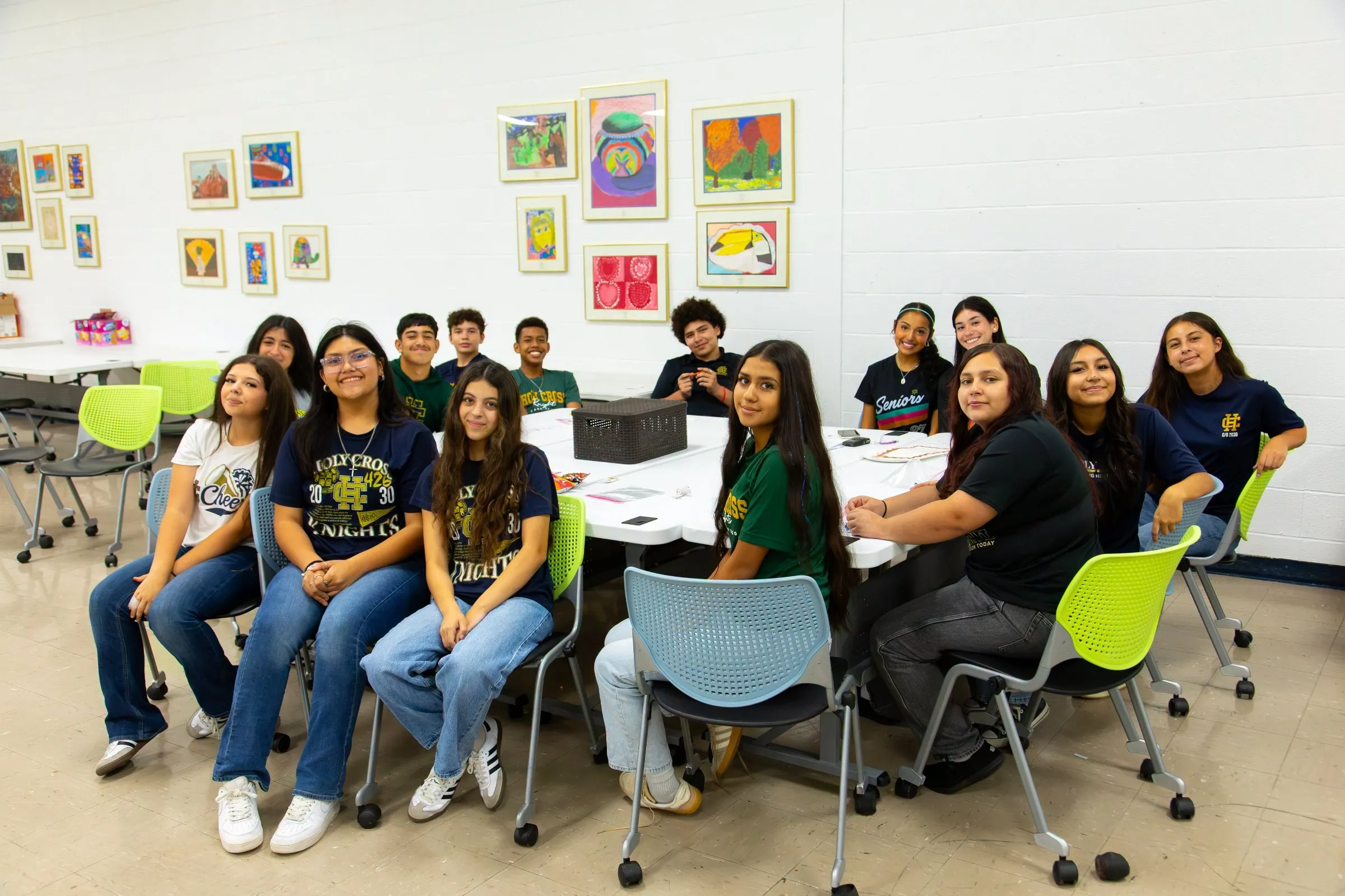 A classroom full of smiling Holy Cross students