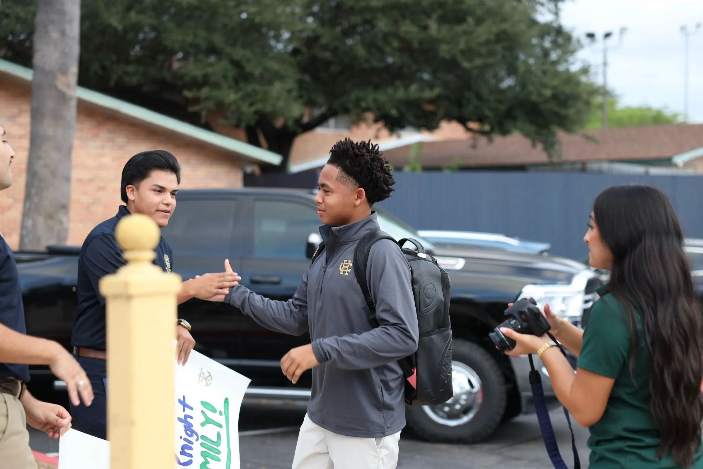 Students and staff greeting each other outside on the first day of school